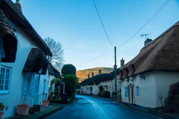 istock Editorial only: Road going through an English village 1176417784