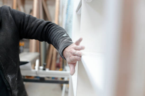 istock Carpenter Sanding Newly Made Cupboard For Painting 1176419931