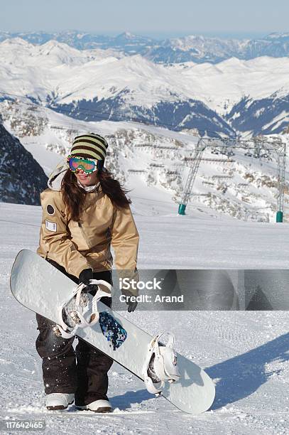 Joven Mujer Practicante De Snowboard Foto de stock y más banco de imágenes de Adulto - Adulto, Adulto joven, Aire libre