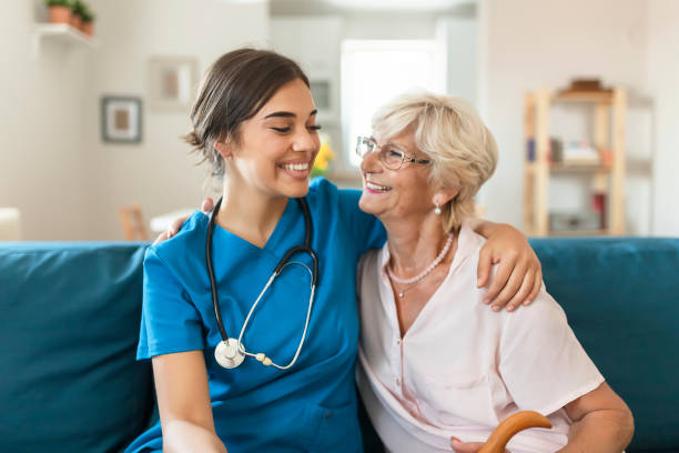 istock Happy senior woman with a nurse 1176424930