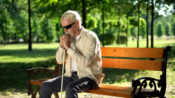 istock Depressed blind man sitting alone in park, socially disadvantaged population 1176425349