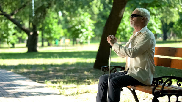 istock Old blind man sitting on bench, thinking about life injustice feeling frustrated 1176425407