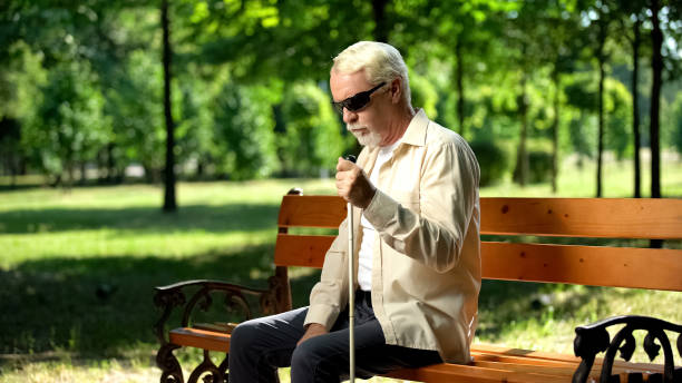 istock Depressed blind man sitting alone in park, socially disadvantaged population 1176426185