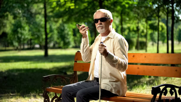 istock Man listening audio message on phone, application for visually impaired people 1176426488