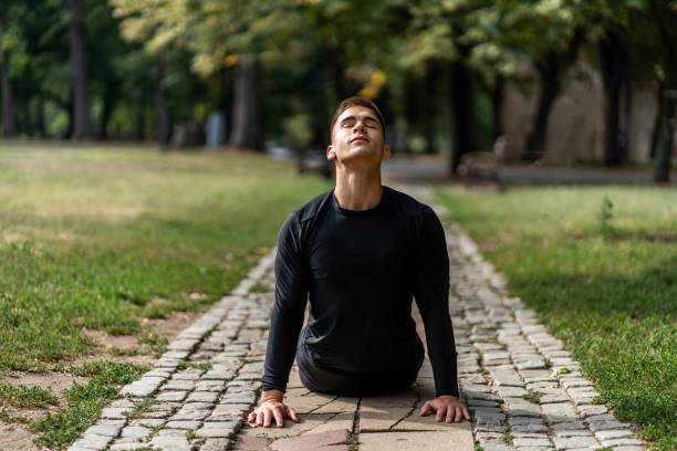 istock Fit man doing yoga workout and stretching back 1176428123