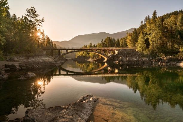 wschód słońca przez belton bridge nad middle fork flathead river w pobliżu lodowca zachodniego w parku narodowym glacier, montana, usa - clear sky reflection sunlight autumn zdjęcia i obrazy z banku zdjęć