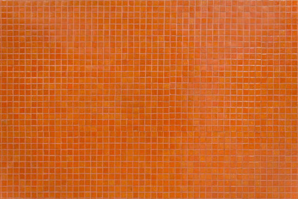 istock Wall orange tiles with little mosaic squares. 1176429478