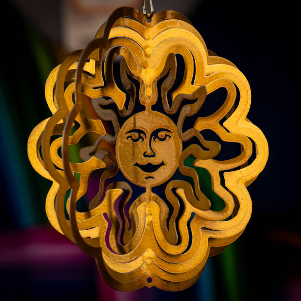 Sun shaped amulet on market Closeup shiny star shaped amulet hanging on blurred background of market stall traditional sun symbol art for sale stock pictures, royalty-free photos & images