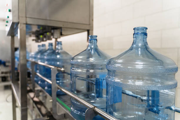istock Empty plastic bottles or gallons on conveyor belt machinery equipment in pure water production factory 1176434954