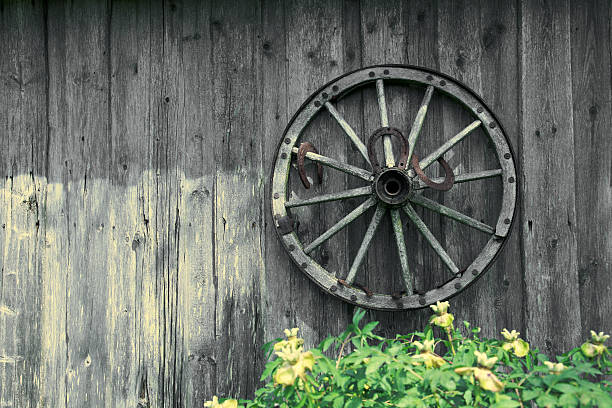 istock Cart wheel on the wooden wall 117643678