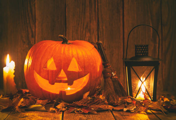 istock Halloween Jack-o-Lantern Pumpkins on rustic wooden background 1176437320