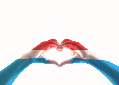 Luxembourg flag pattern on people heart shape hands isolated on white background (clipping path)