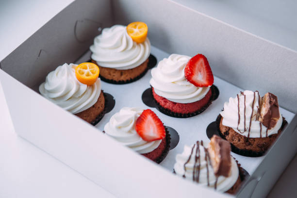istock Cupcake packaging, delivery box, vanilla cupcakes with cream, selective focus, close up. 1176438713