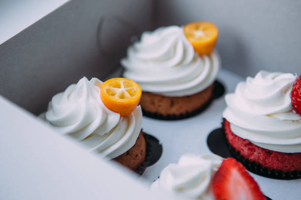 istock Cupcake packaging, delivery box, vanilla cupcakes with cream, selective focus, close up. 1176438719