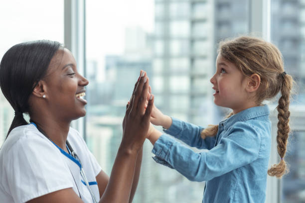 istock Child patient playing patty cake with doctor 1176438827