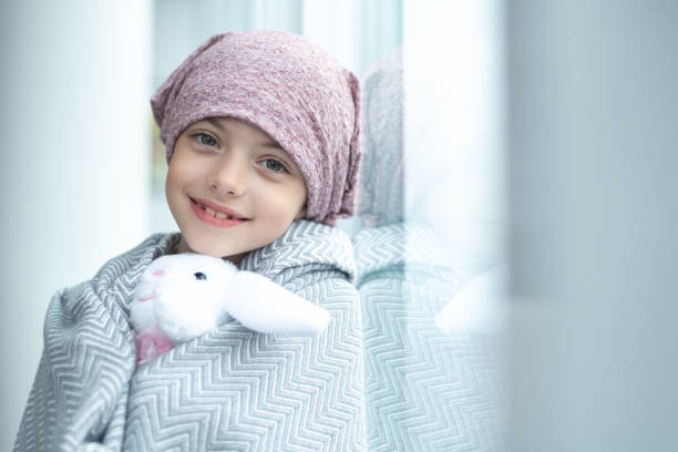 portrait of a girl with cancer holding a stuffed toy - sick girl imagens e fotografias de stock