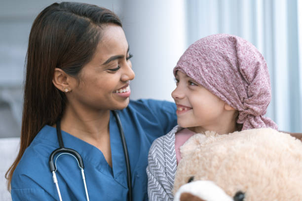 istock Kind doctor comforts girl with cancer 1176438908