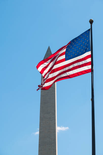 istock US Flag and Washington Monument, Washington DC, USA 1176439667