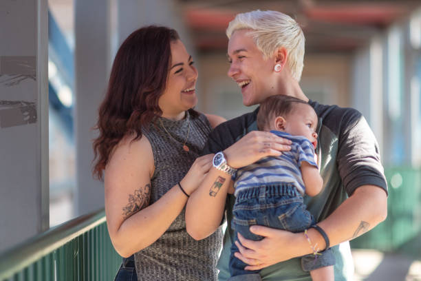 istock Happy LGBT couple bonding with baby 1176440418