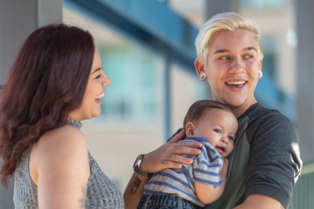 istock Lesbian couple bonding with baby 1176440419