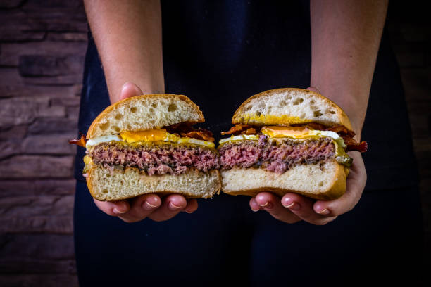 istock Craft beef burger with cheese, egg, bacon and pickles on wood table and rustic background 1176445840