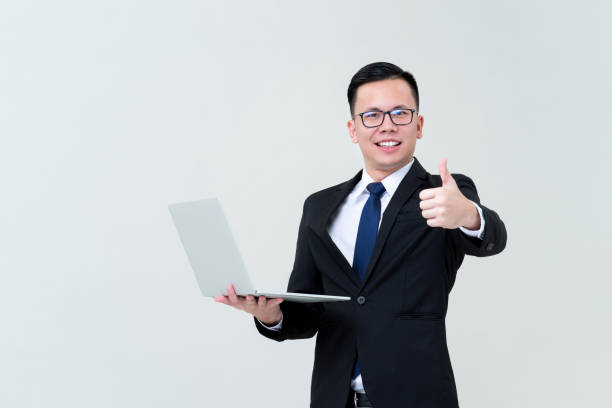 istock Businessman with laptop computer giving thumbs up 1176446059