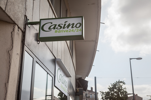 Picture of a sign with the logo of Casino on their local supermarket in Lyon, France. Casino Group or Casino Guichard-Perrachon is a French mass-retail Group of supermarkets, hypermarkets and convenience stores