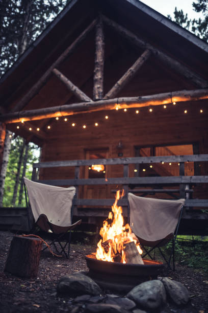 istock Campfire in front of a rustic house in the forest 1176456106
