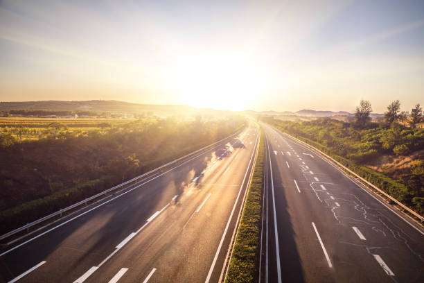 istock Sunset on straight country road 1176458073