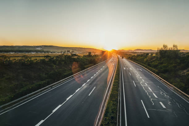 istock Sunset on straight country road 1176458082