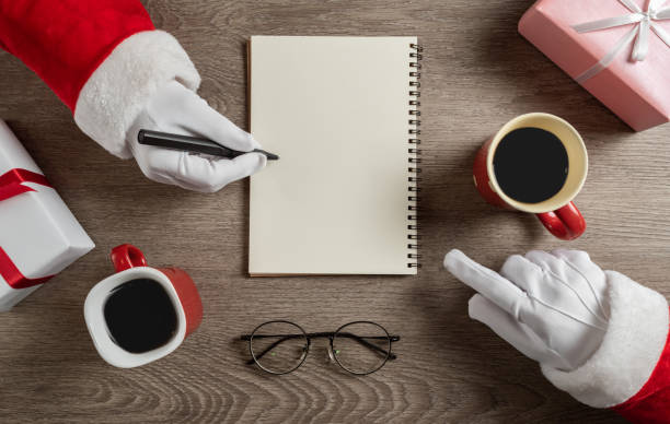 istock Santa clauses talking for christmas trips. 1176460824