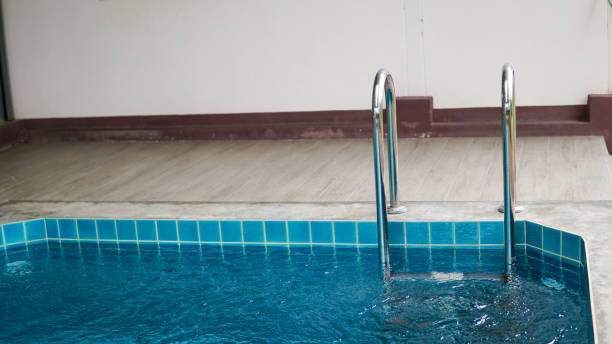 istock Grab bars ladder in the blue swimming pool 1176461678
