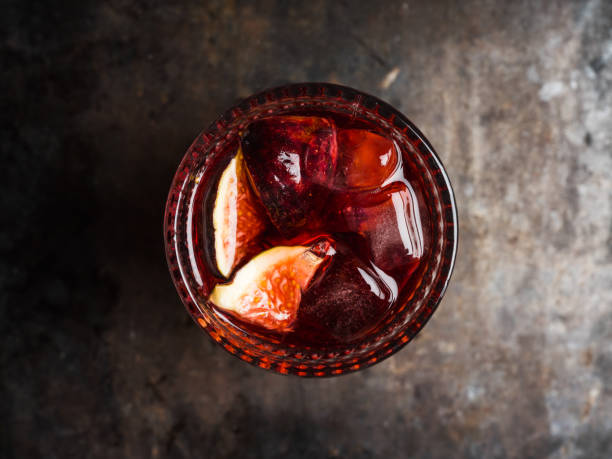 istock Old-fashioned cocktail with figs on the rustic background 1176461679