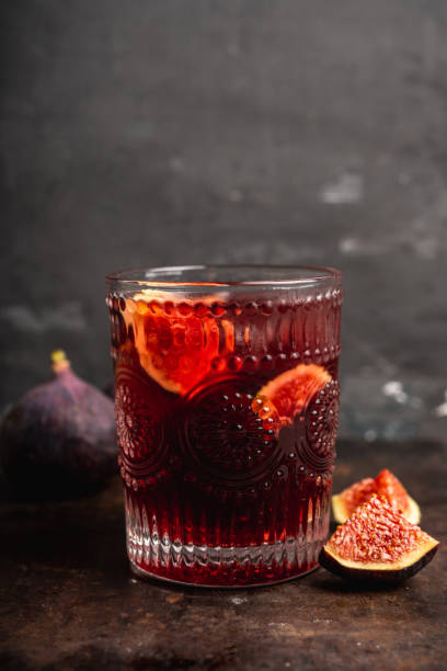 istock Old-fashioned cocktail with figs on the rustic background 1176461695