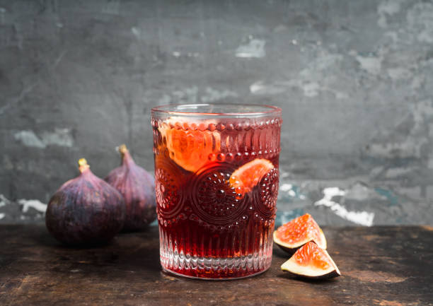 istock Old-fashioned cocktail with figs on the rustic background 1176461700