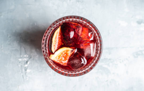 Old-fashioned cocktail with figs on the rustic background
