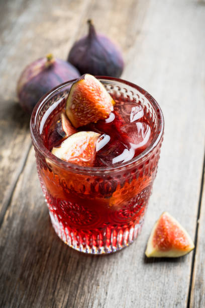 istock Old-fashioned cocktail with figs on the rustic background 1176461737