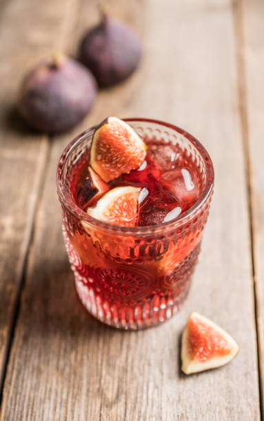 istock Old-fashioned cocktail with figs on the rustic background 1176461742