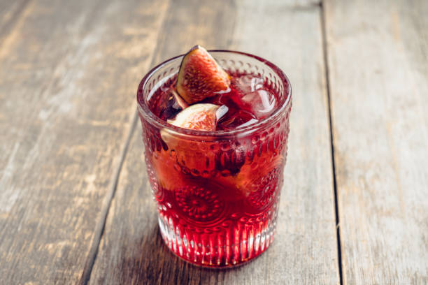 istock Old-fashioned cocktail with figs on the rustic background 1176461754