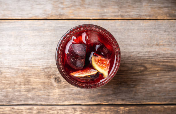 istock Old-fashioned cocktail with figs on the rustic background 1176461768