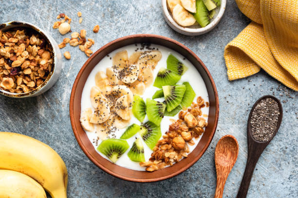 istock Breakfast smoothie bowl with granola, fruits and yogurt 1176462497