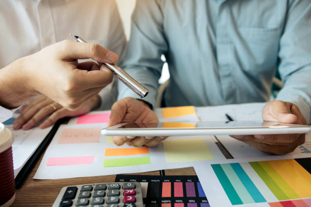 istock Two businessmen are working analyzing the company annual budget and using digital tablet to find information data result. 1176464529