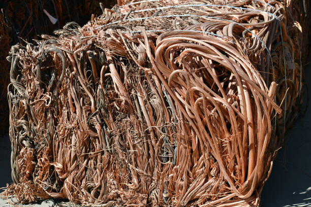 istock Copper wire and tubes crushed into a cube at scrap metal recycling plant 1176466057