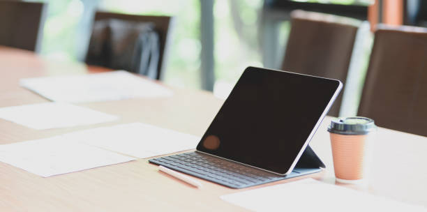 istock Modern workplace with tablet and a cup of coffee on wooden table 1176469815
