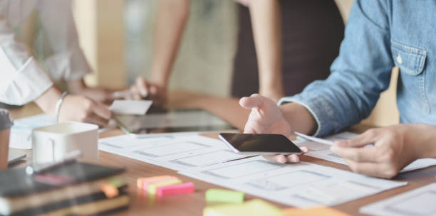 istock Close-up of UX web developer planing the idea on smartphone application together 1176469819