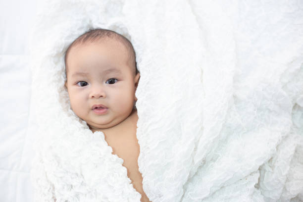 istock Cute little baby looking into the camera 1176471597