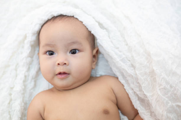 istock Cute little baby looking into the camera 1176471600