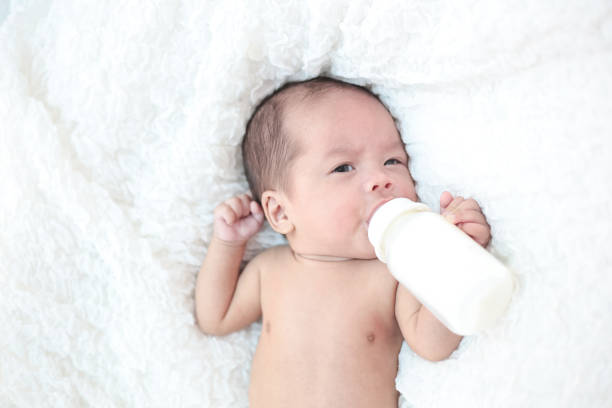 istock Newborn babies suck milk at the bottle. 1176471633
