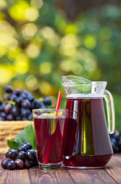 istock grape juice in glass and jug 1176476580