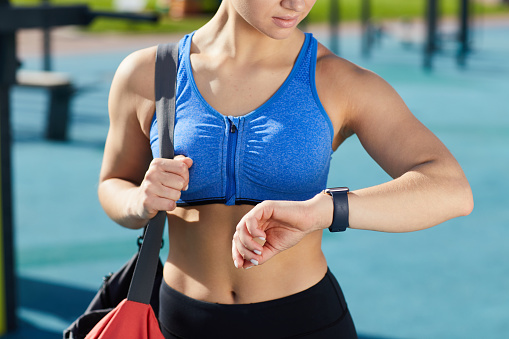 Fitness girl checking message on smartwatch